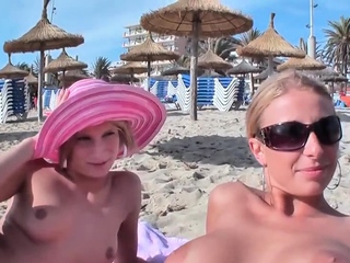 Two blonde sluts seduced into a threesome on the beach