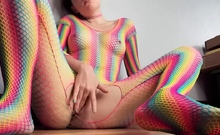 Teen in Rainbow Fishnets Fingers Herself